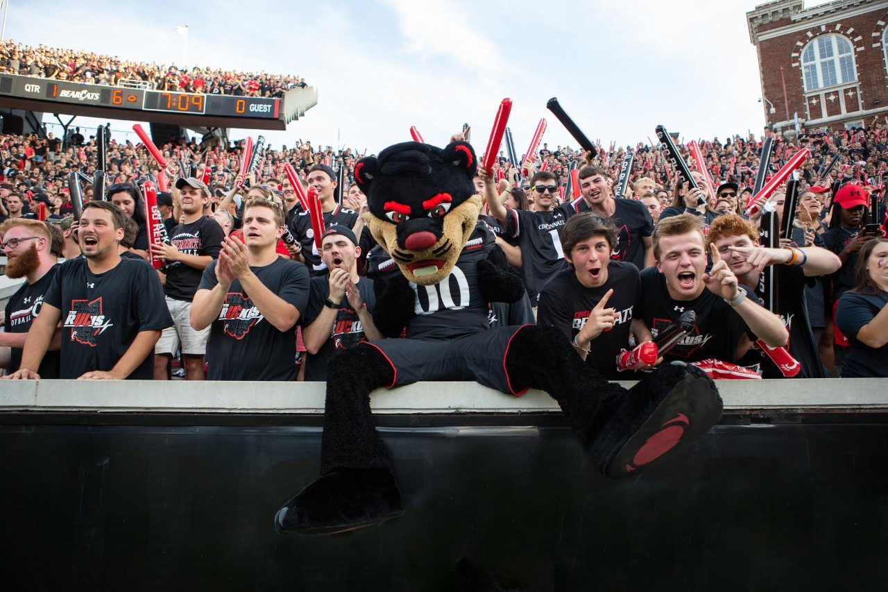 University of Cincinnati students cheering in the student section at a Big 12 football game