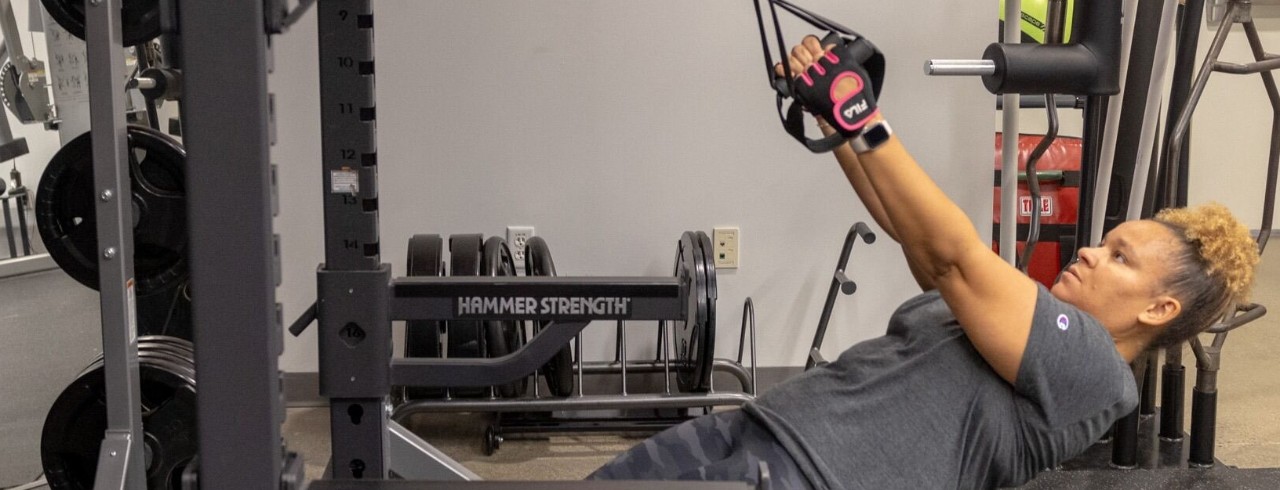 A guest uses the weights at the Campus Recreation Center.