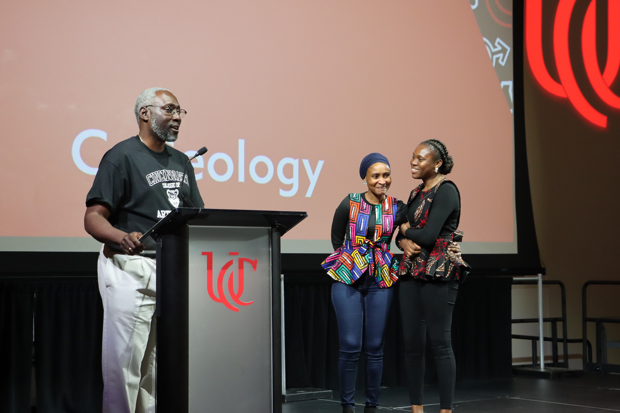 Dean James Mack presents the winners of the Discovery In Action student poster competition.