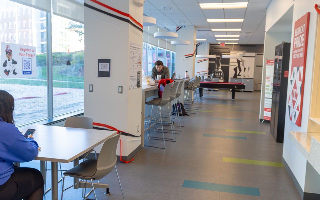 Lobby with tables, high top work surfaces and pool table. Windows are across the entire length of room