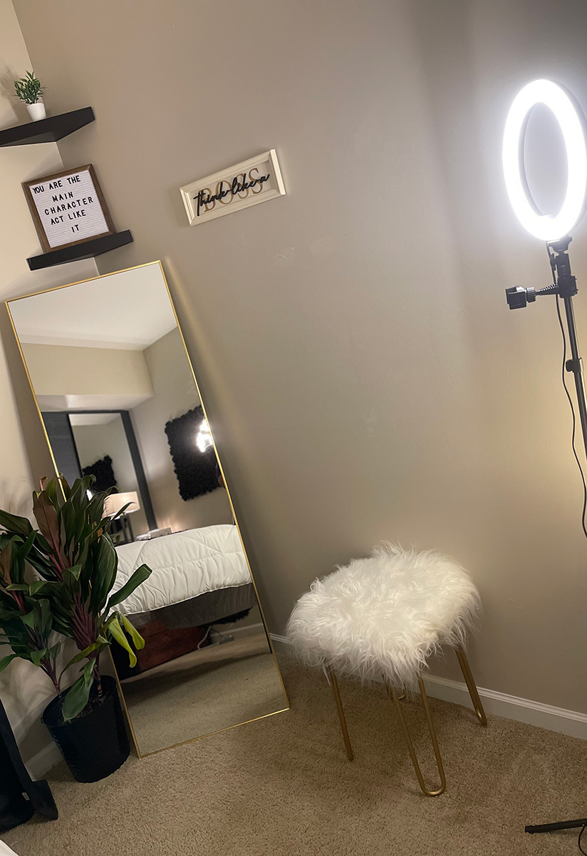 Lighting and mirror decorate a corner of the room