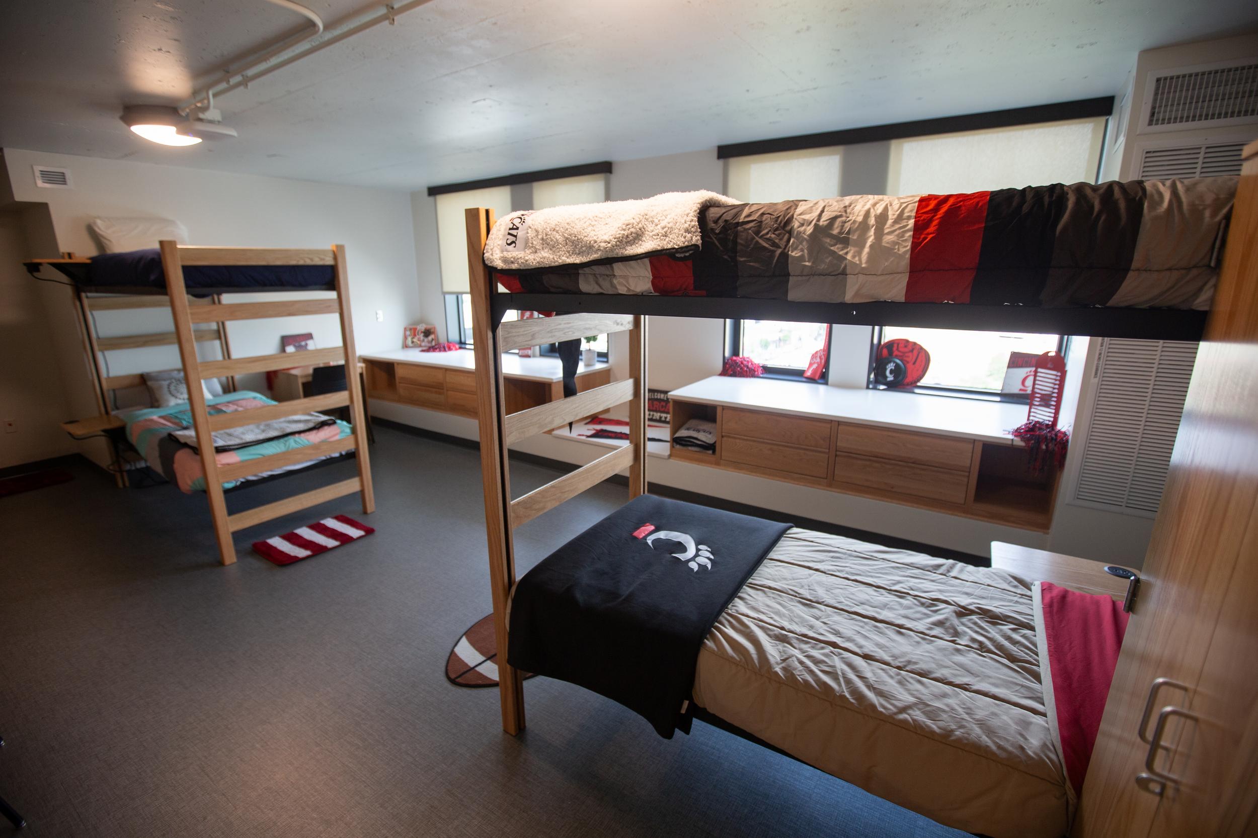 Room with two bunk beds and large windows