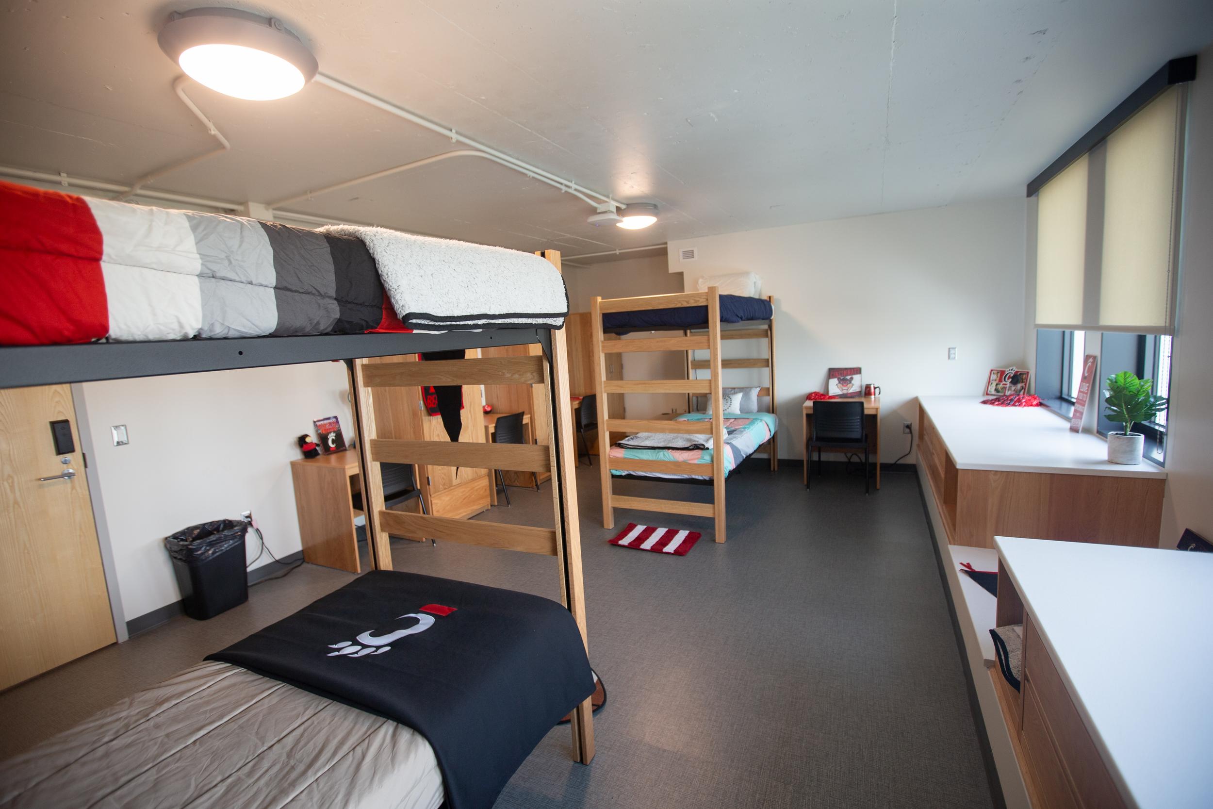 Room with two bunk beds and storage