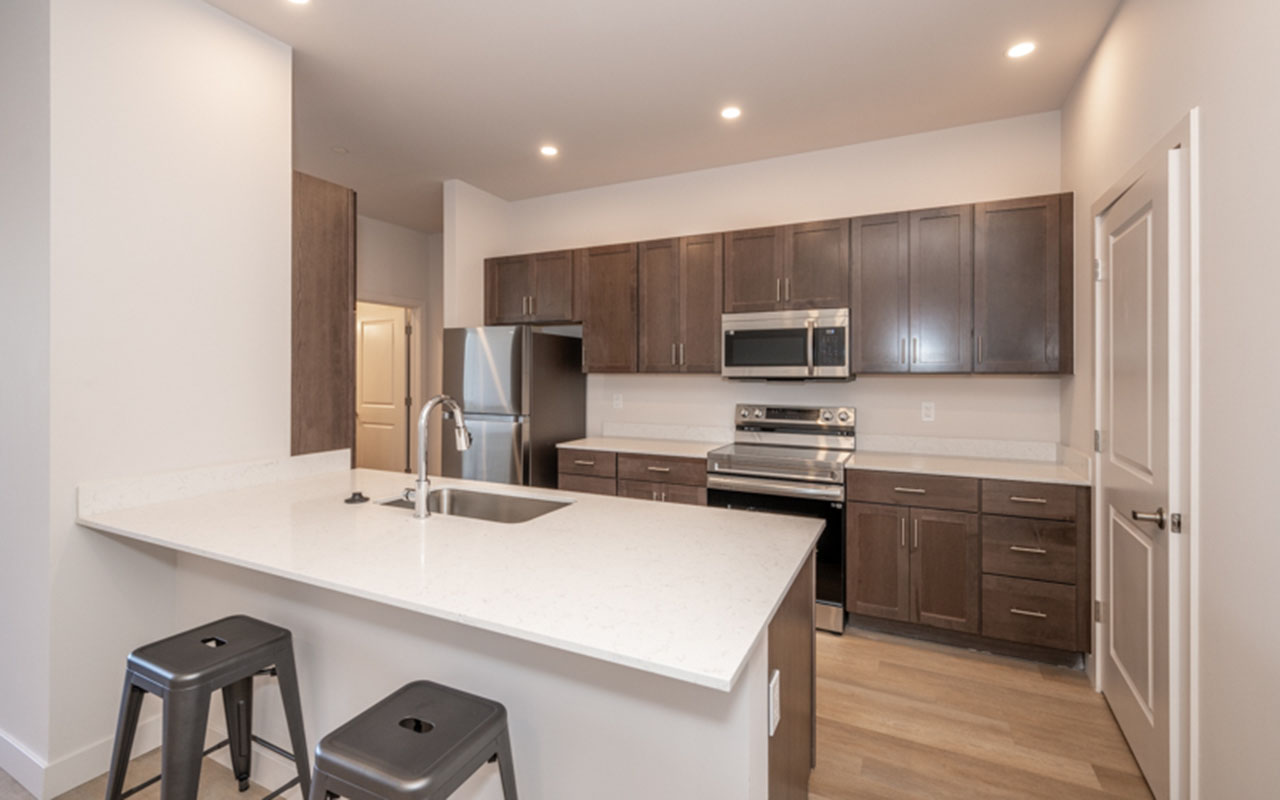 Kitchen with high counter and stools