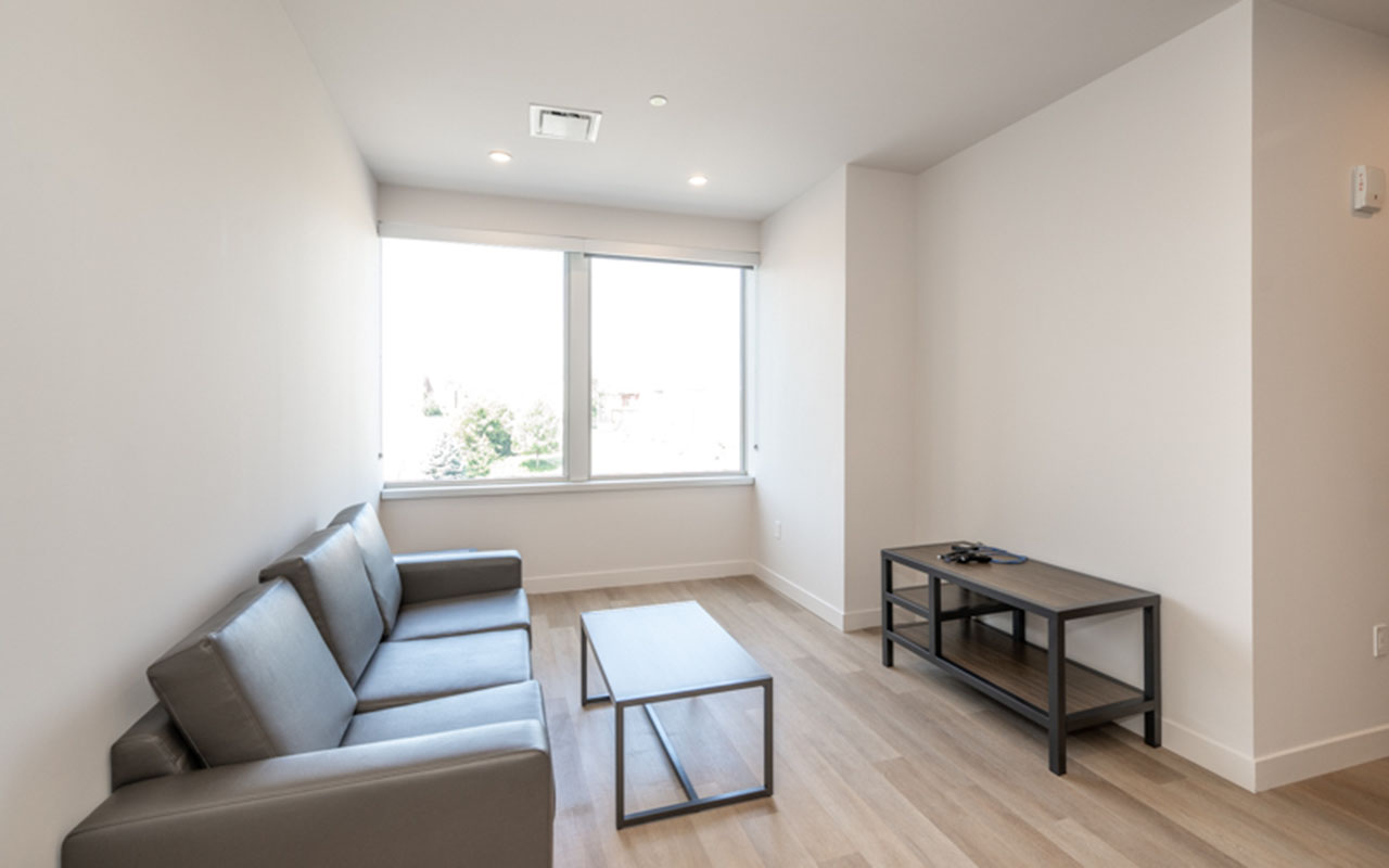 Living area with sofa, coffee table and entertainment center