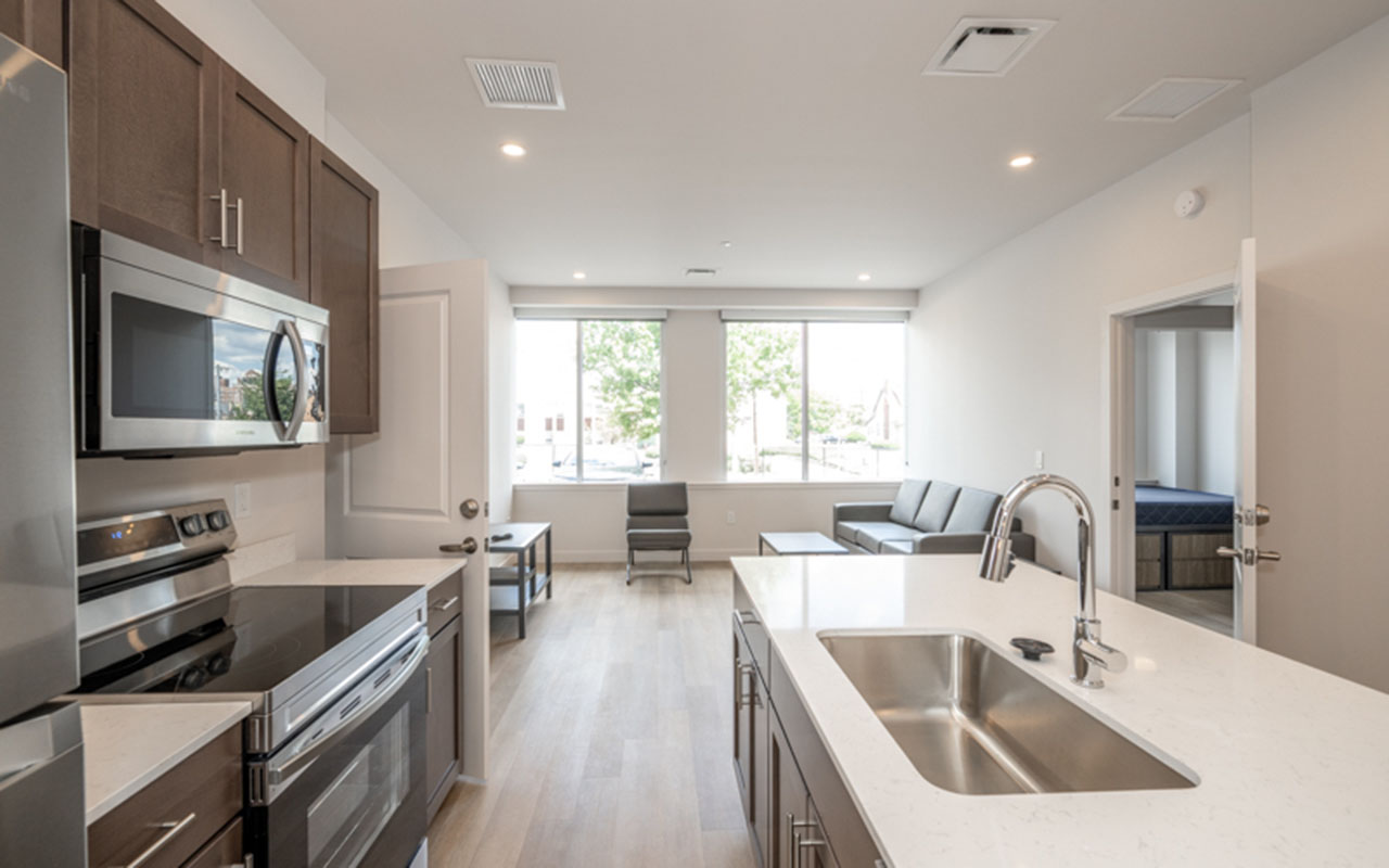 Kitchen with living area in background