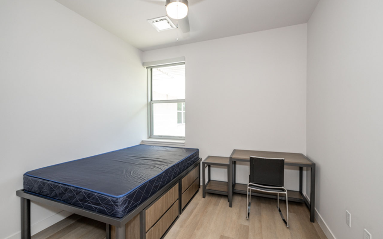 Bedroom with storage bed, nightstand and desk with chair