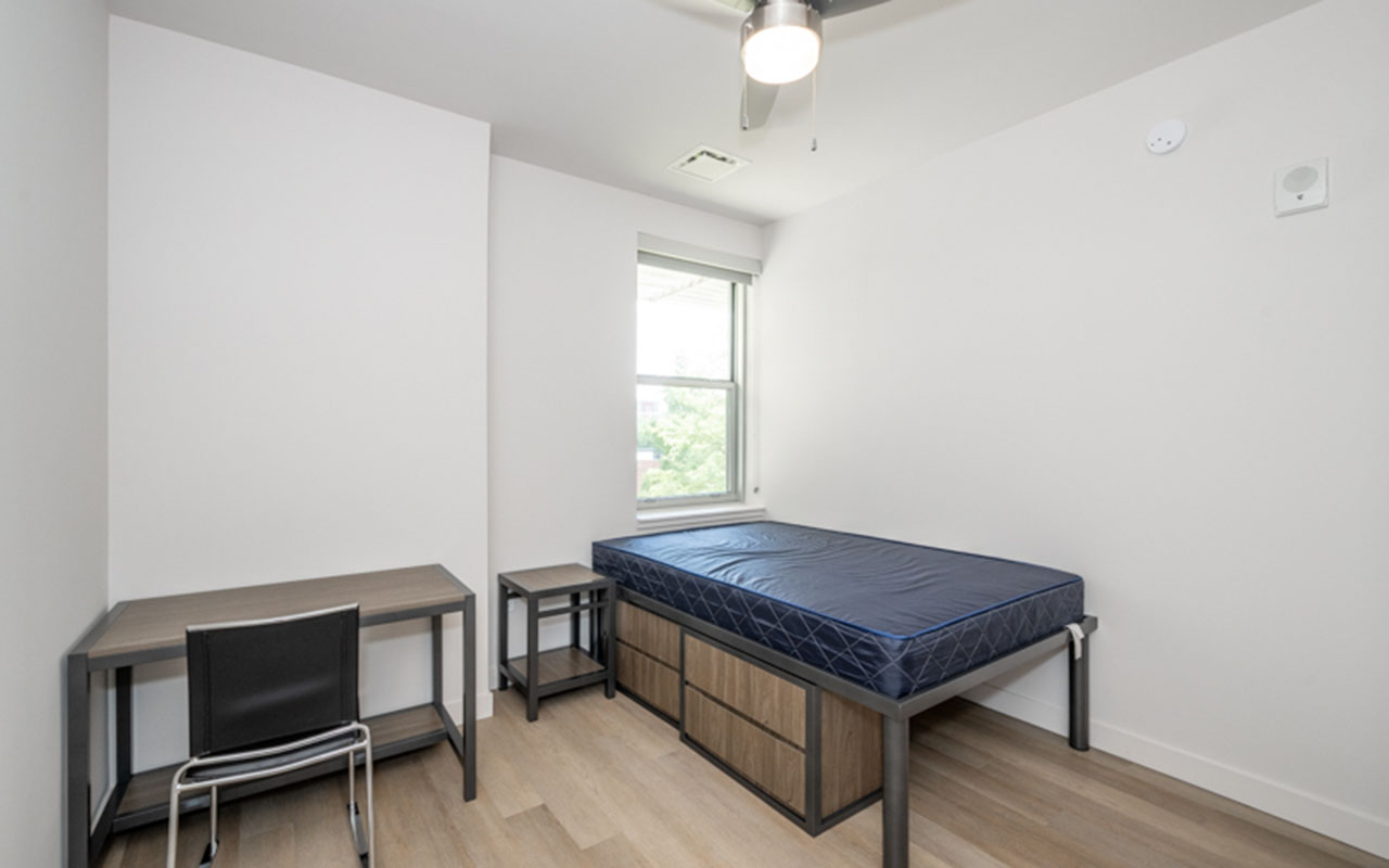 Bedroom with storage bed, nightstand and desk with chair