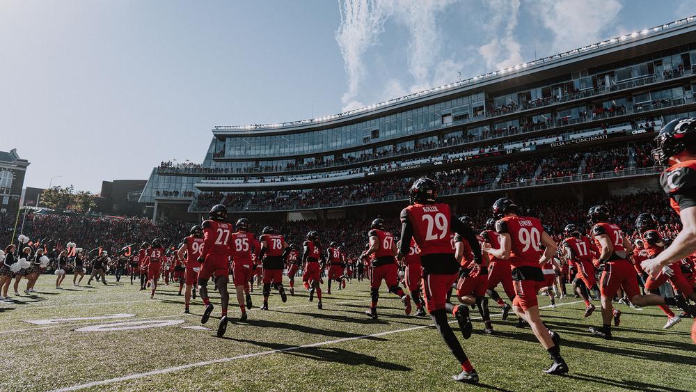 The University of Cincinnati football team takes the field