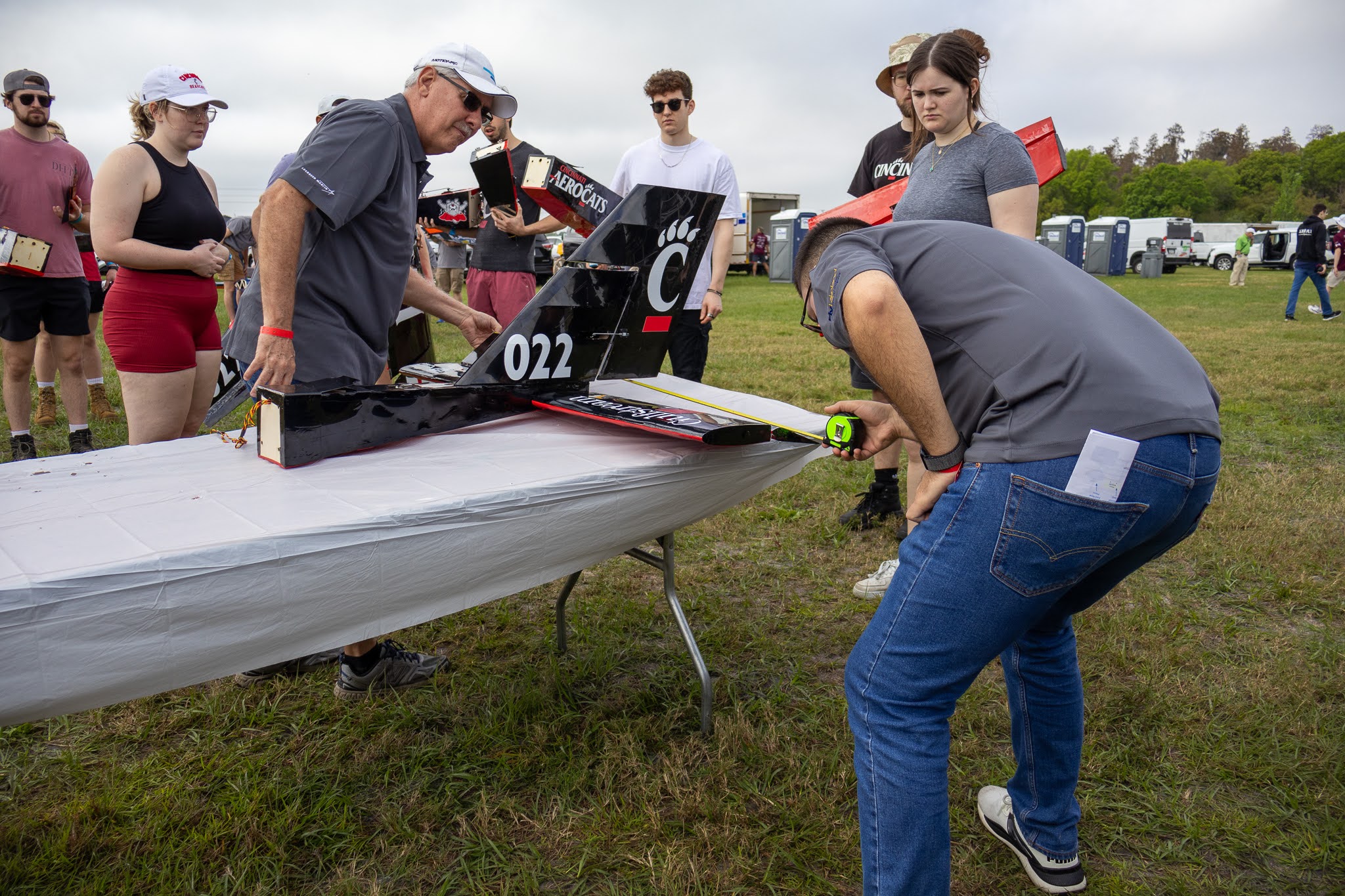 Competition judges measure the sections of the regular plane. 