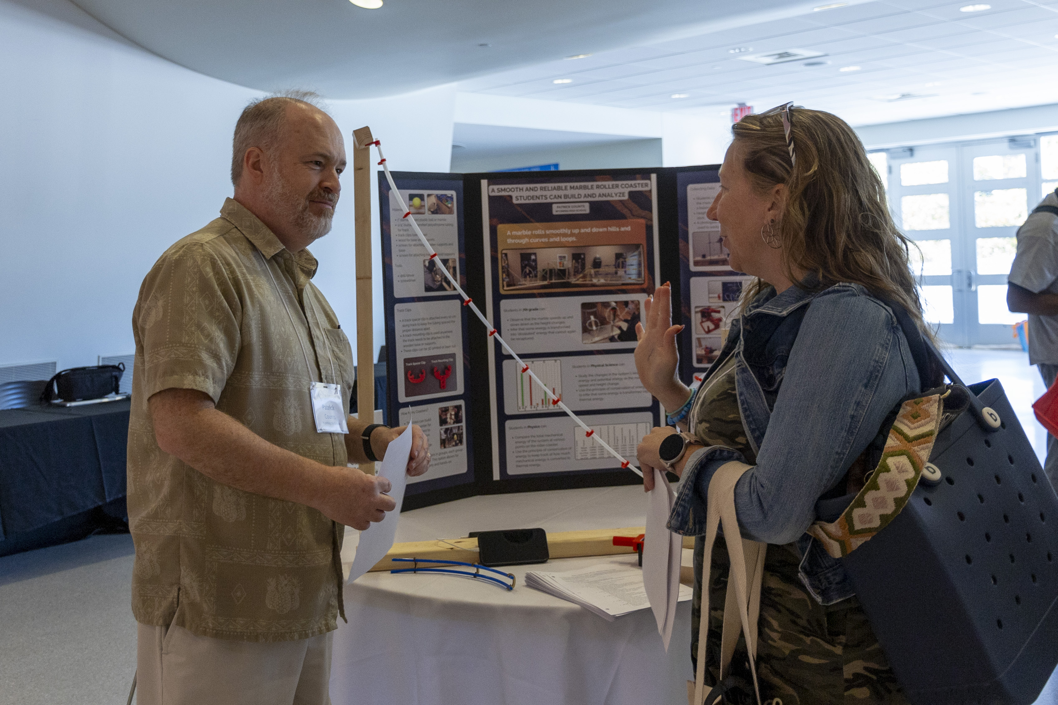 Educators present their STEM+ projects for the audience around the TUC Great Hall.