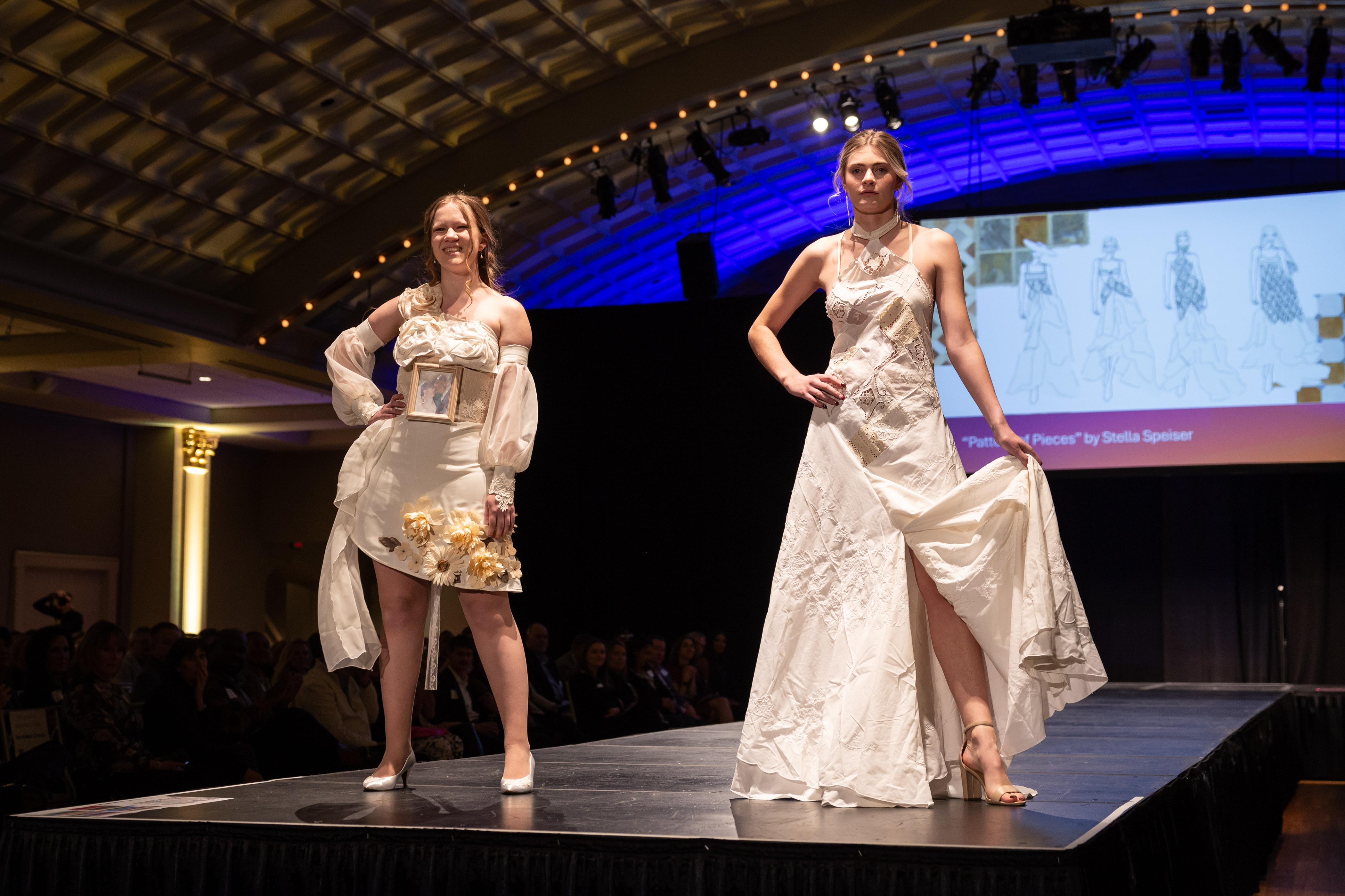 Two models on the runway wearing ensembles created from thrifted items