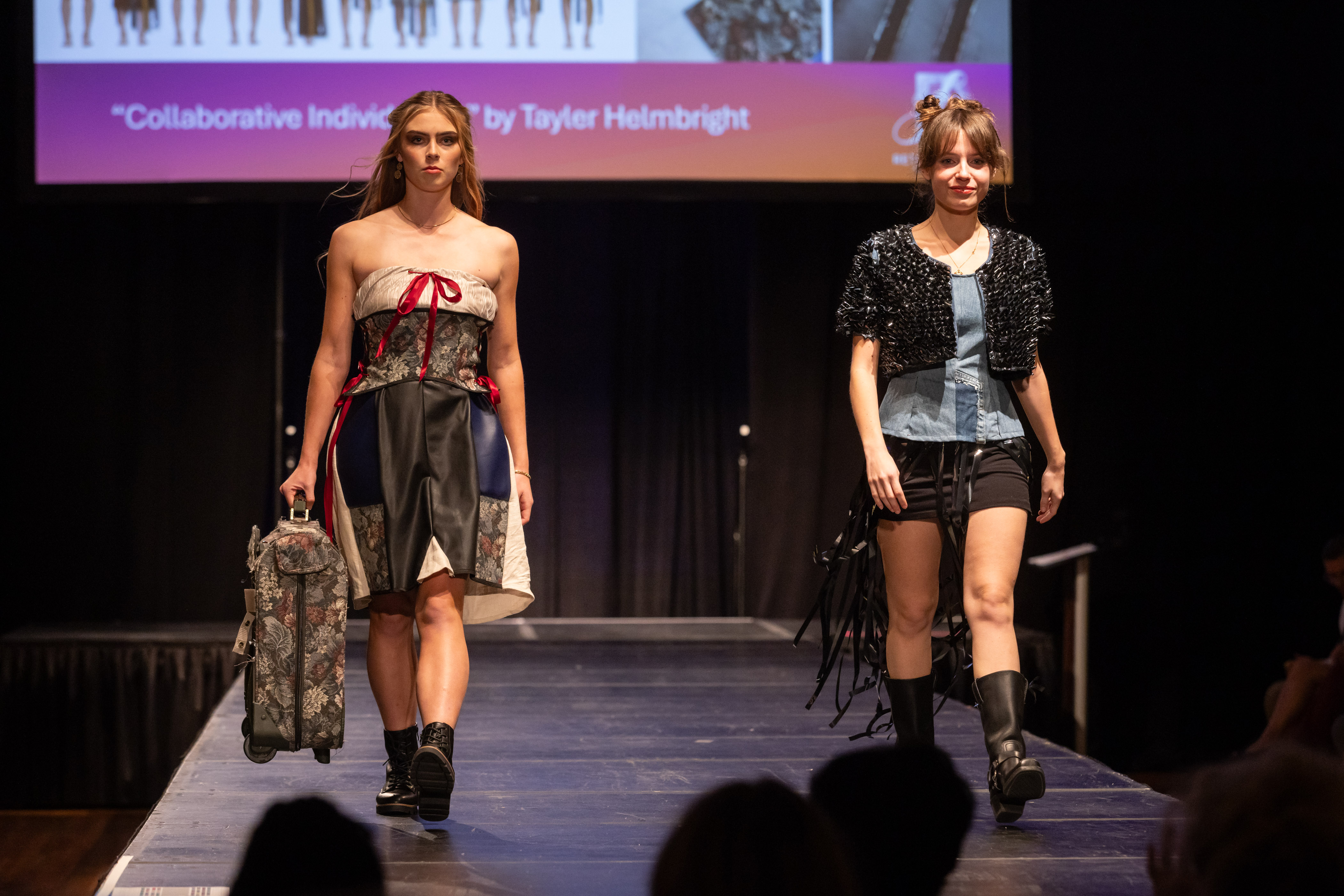 Two models on the runway wearing ensembles made from thrifted items