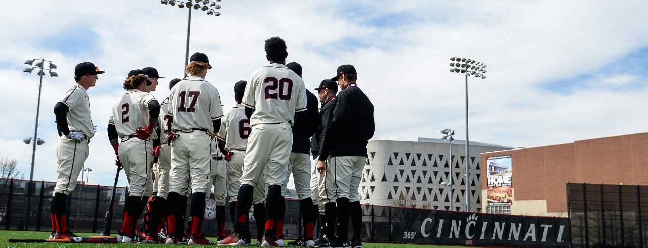 UC Bearcats baseball team stands on field