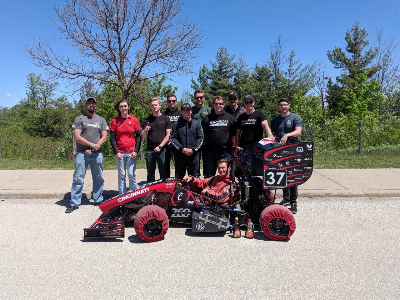Bearcat Formula SAE team with their car at Canada competition