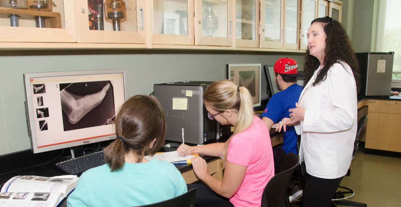 Professor Heather Moore with students in the lab