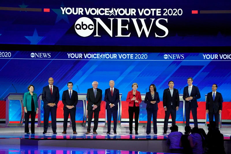 presidential candidates stand on a stage