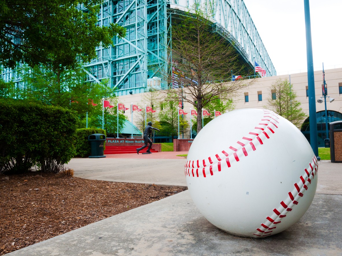 large baseball in front of building