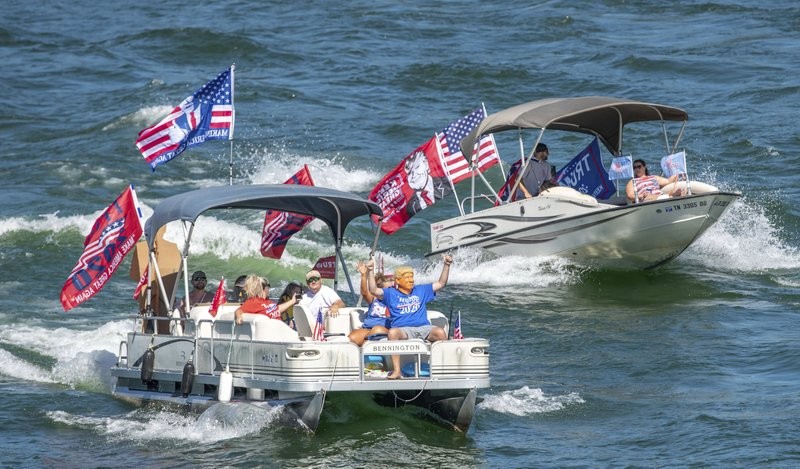 Trump supporters on boats with flags and signs