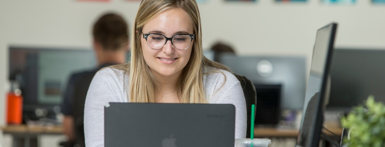 Lifelong learner works on her laptop in an office