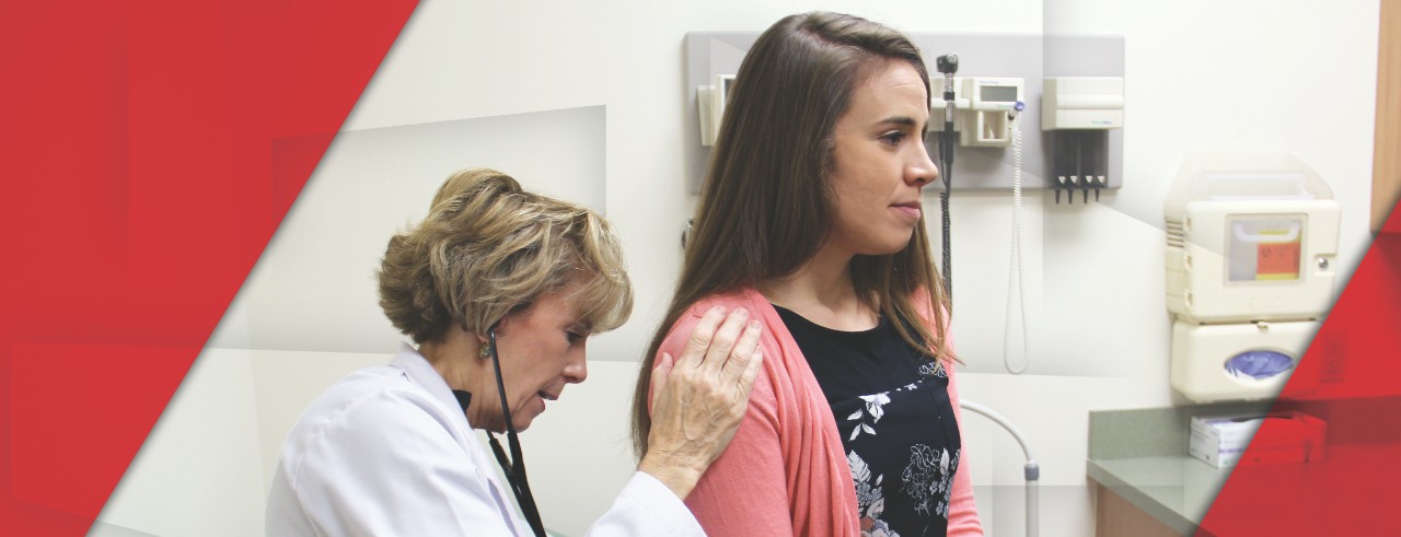 Christine Colella examines a female patient 