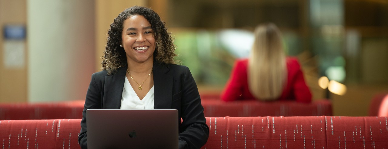 Woman smiling using a laptop