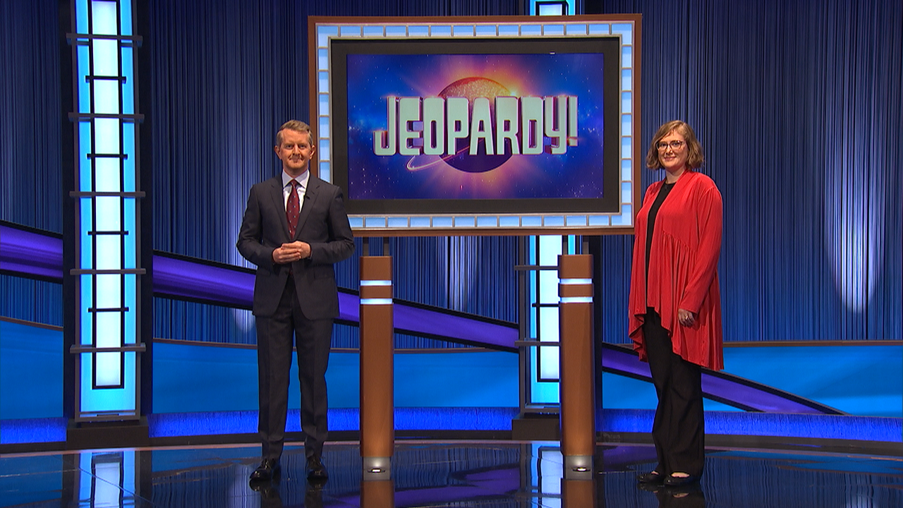 UC Classics Professor Kelly Shannon-Henderson appears on stage with Jeopardy! host Ken Jennings.