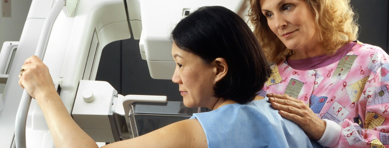 A woman receives a mammogram.