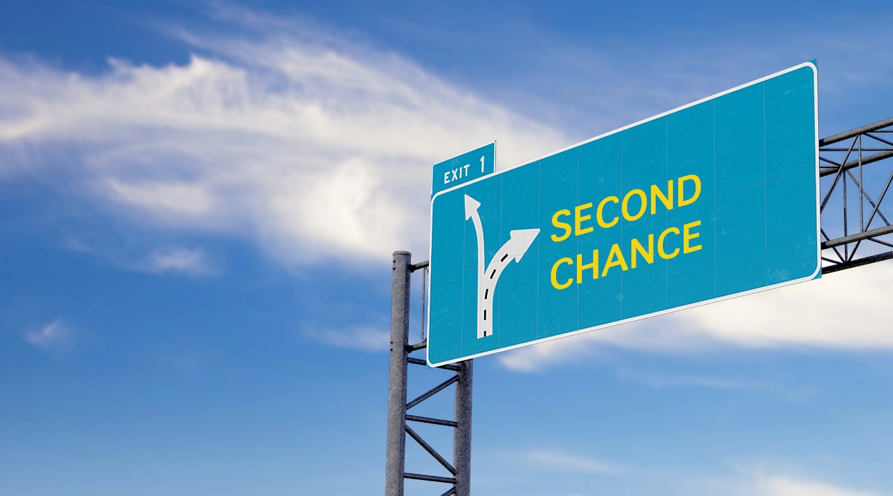 exit road sign showing the words second chance