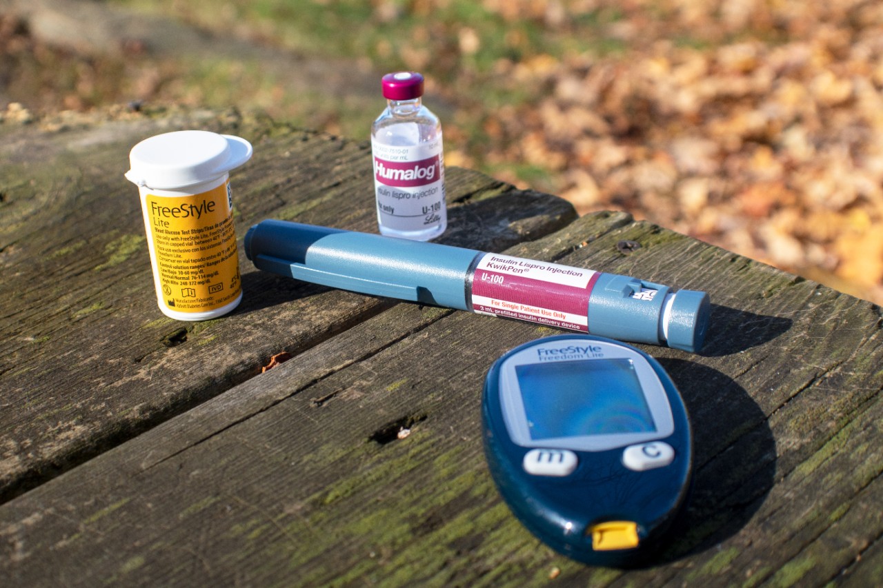 Items used to test blood glucose levels on a picnic table