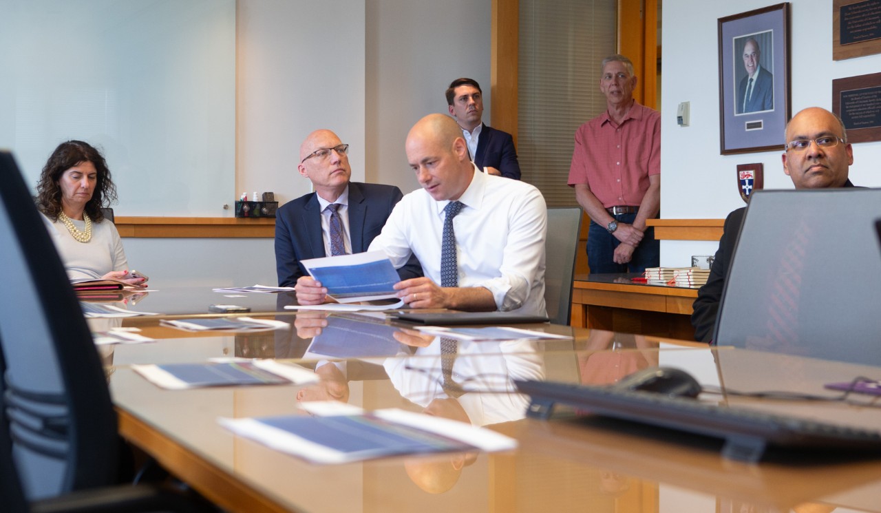 U.S. Rep. Greg Landsman sits at a conference table with Dean John Weidner, Assistant Dean Gautam Pillay and other faculty from UC's College of Engineering and Applied Science.