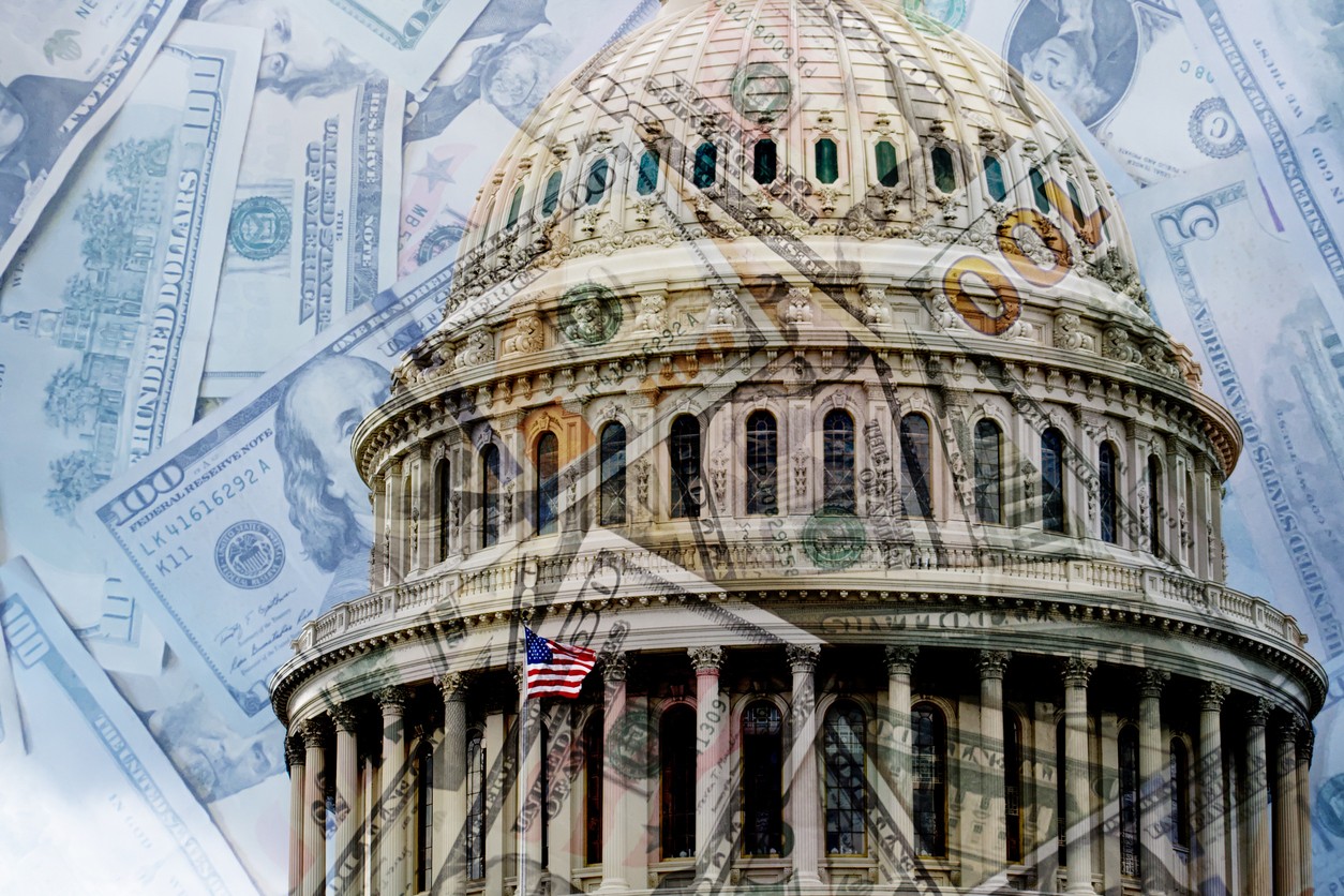 Photo of Congressional building with money in the background, representing American politics and markets