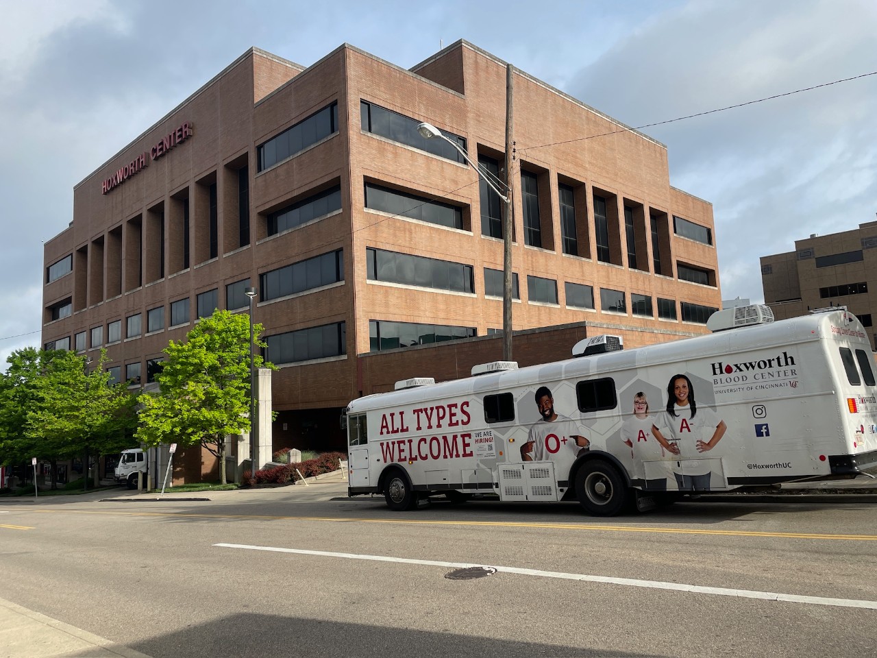 A blood donation bus outside of the Hoxworth Blood Center building