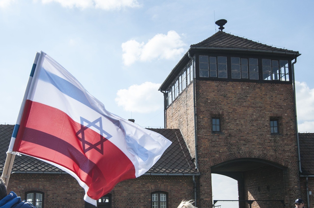 Flag flies above the entrance to Aushwitz-Birkenau