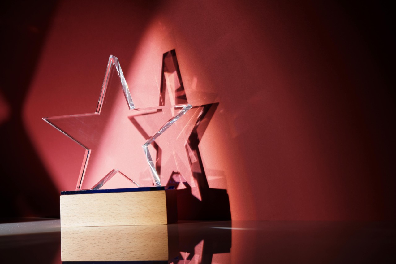 star-shaped crystal trophy against red background
