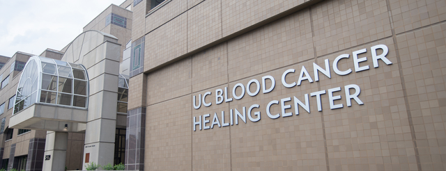 Outside of a building with a sign reading "UC Blood Cancer Healing Center"