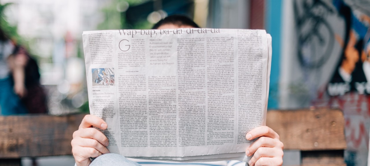 A person reading a newspaper