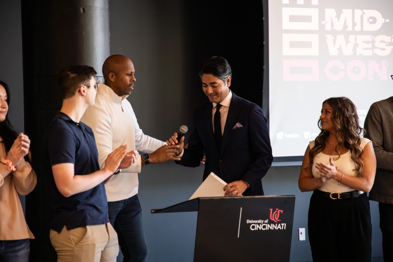 Rob Richardson and Mayor Aftab Pureval greet each other at a podium.