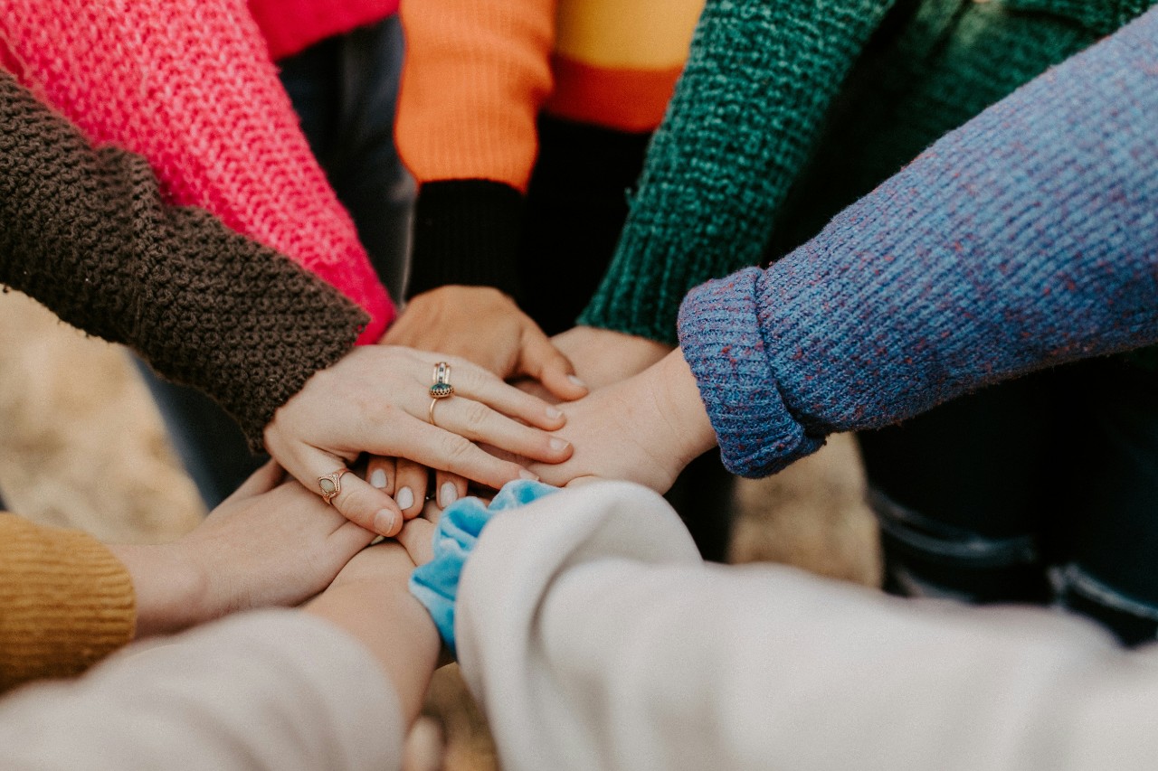 Hands in a unity circle.