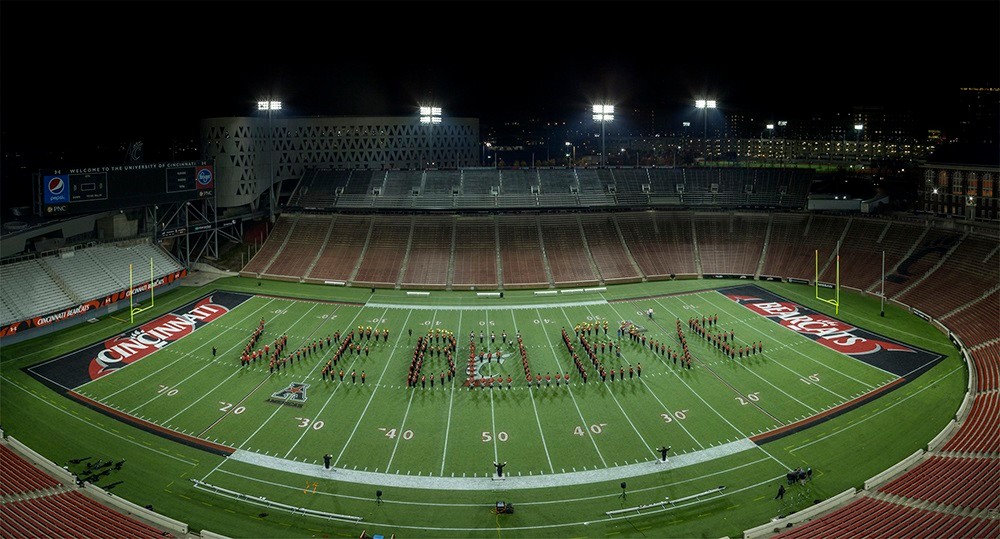 The University of Cincinnati marching band spells out "We Believe" on the field in Nippert Stadium.
