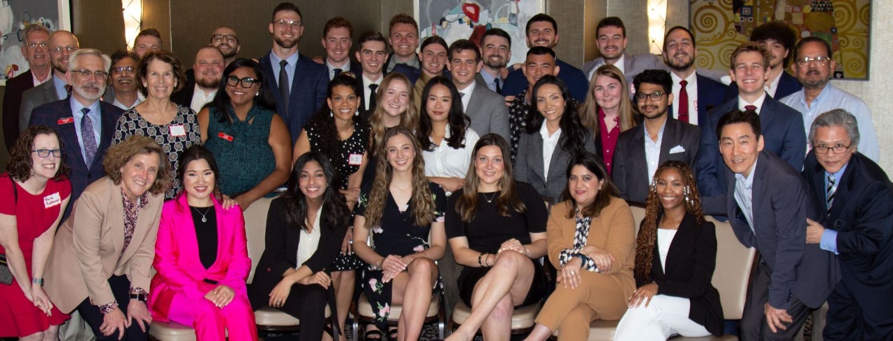 The 2024 Lindner MBA class poses together in four rows of people with the front row seated