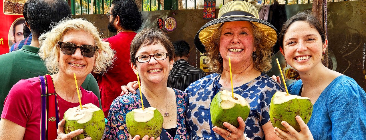 UC advisors Julie Steimle, Lorri Blanton, Suzette Combs and Mega Tobin in Bangalore, posing with fresh coconuts to drink