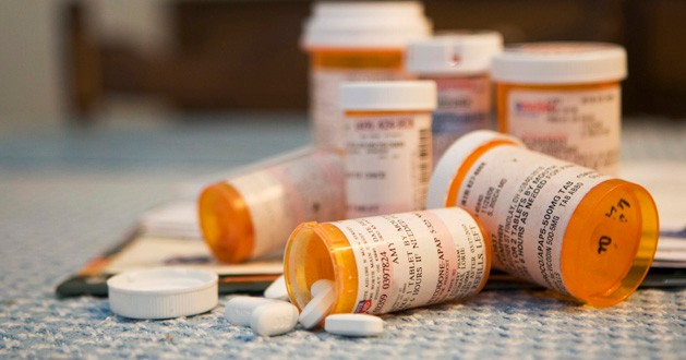 A collection of prescription drug bottles and pills