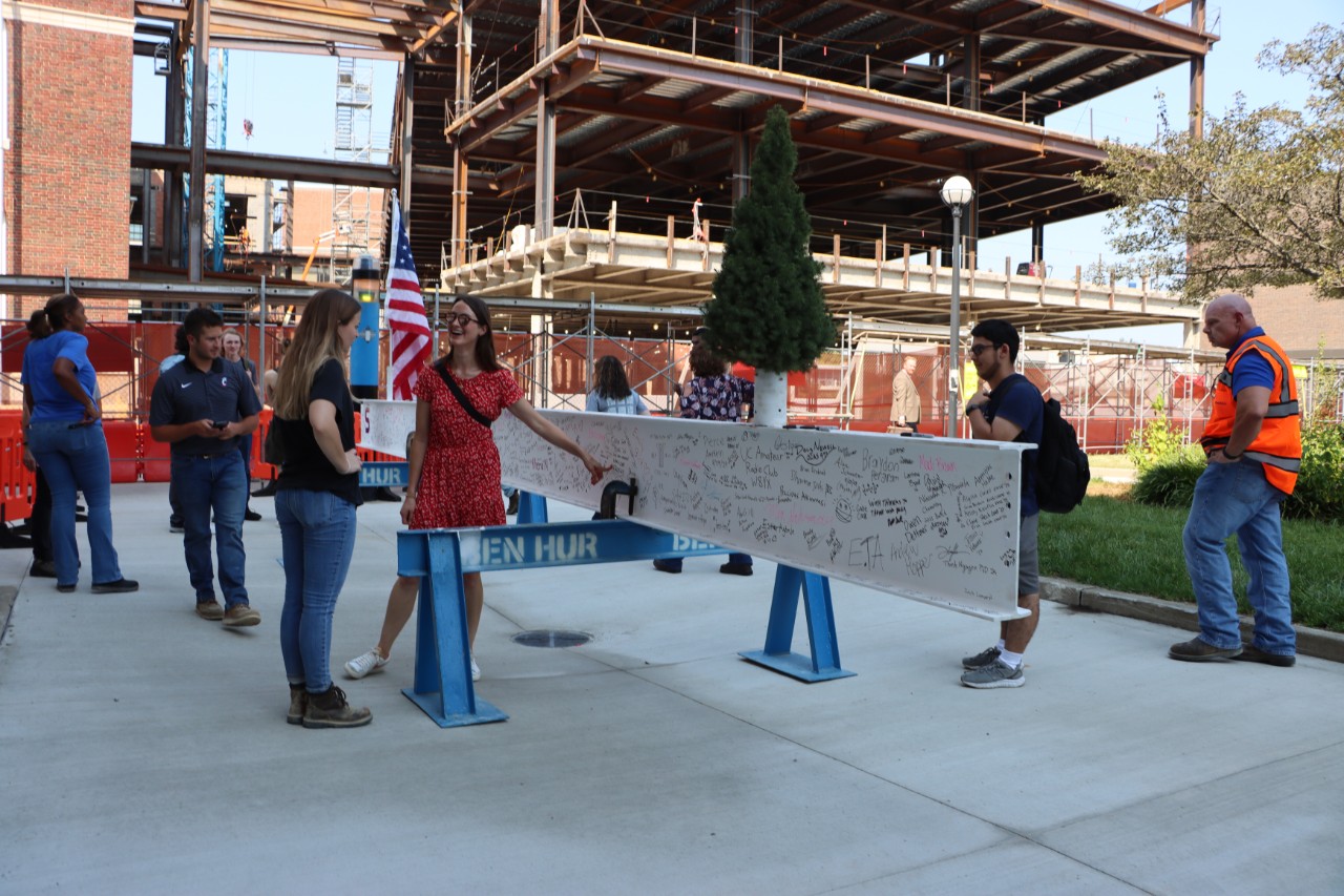 Students, faculty and staff attend the beam signing at UC's Old Chemistry building.