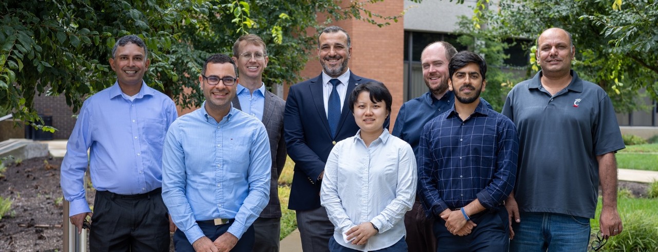 new engineering faculty pose together outdoors