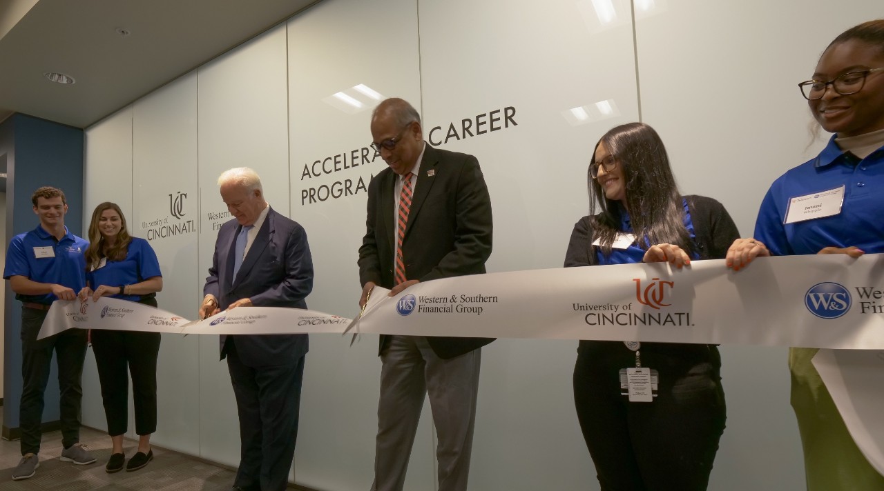 President Neville Pinto and John Barrett cut a ribbon for the opening of the Western & Southern Accelerated Career Program.