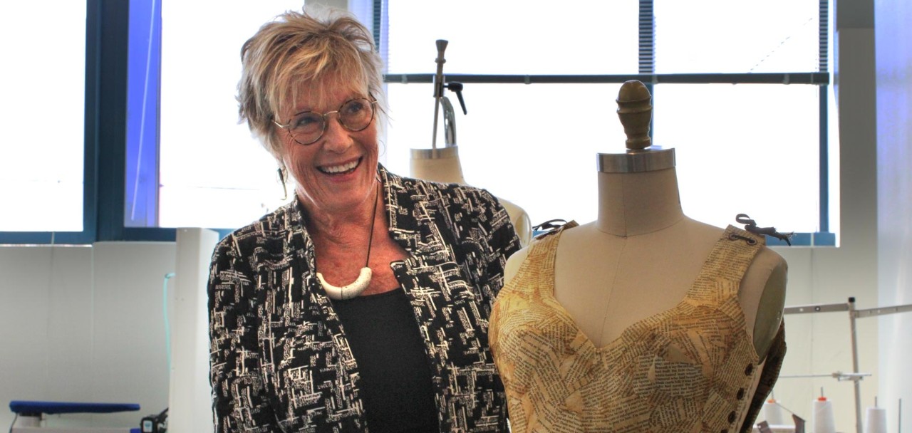 headshot of Laurie Wilson in the design studio with a fashion mannequin 