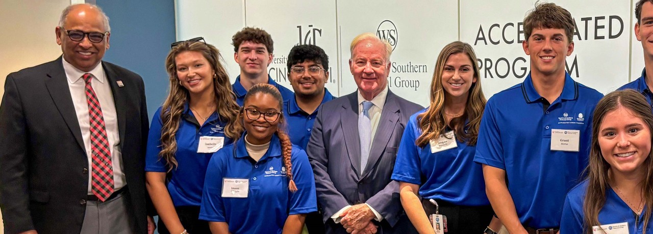 UC President Neville G. Pinto and Western & Southern Chairman, President, and CEO John F. Barrett with students at ribbon cutting for Western & Southern Accelerated Career Program. 