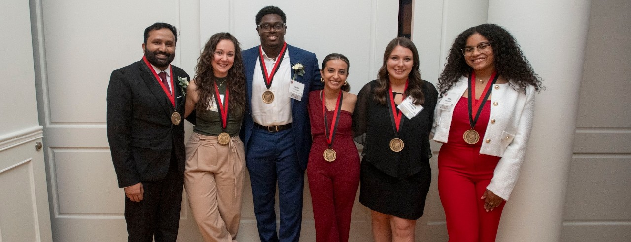 University of Cincinnati students post during award ceremony.