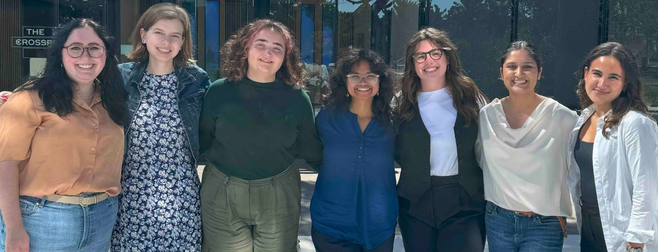 NIS students pose for a photo in front of a building.